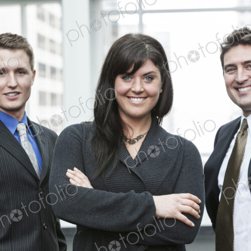 A group portrait of three business people, with a caucasian woman as the lead. A group portrait of three business people, with a caucasian woman as the lead.