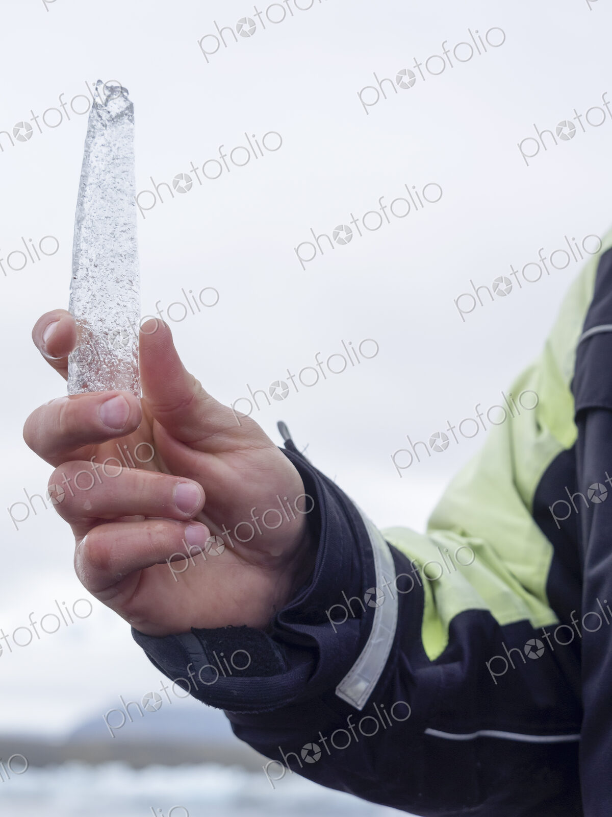 A guide holding an ice core sample from the Glacial Lagoon in his hand.