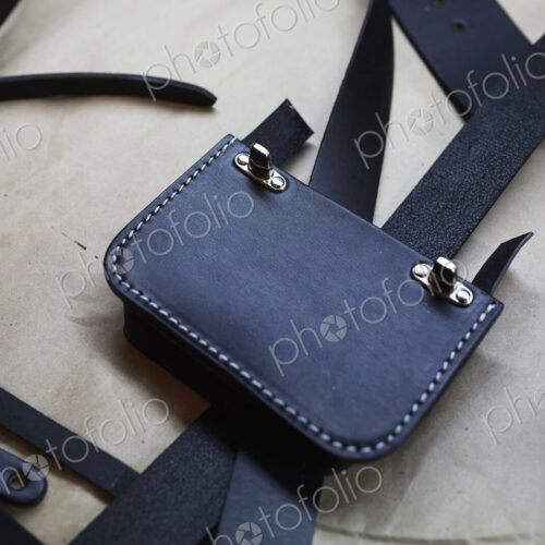 A handmade blue leather bag, strap, component part parts, scissors and hand tools. A handmade blue leather bag, strap, component part parts, scissors and hand tools.