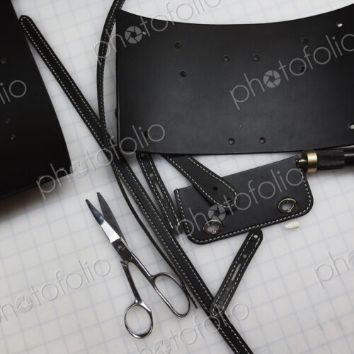 A handmade blue leather bag, strap, component part parts, scissors and hand tools. A handmade blue leather bag, strap, component part parts, scissors and hand tools.