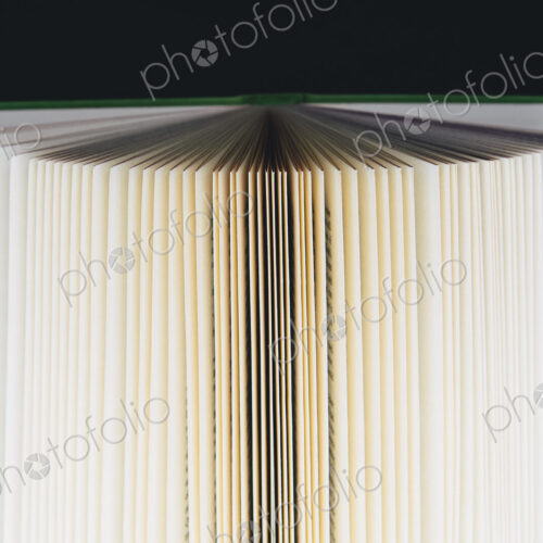 A hard cover printed book, opened and upright. Pages fanned out with graduated… A hard cover printed book, opened and upright. Pages fanned out with graduated…