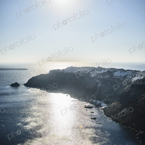 A headland on an island, sun reflecting on water. A headland on an island, sun reflecting on water.