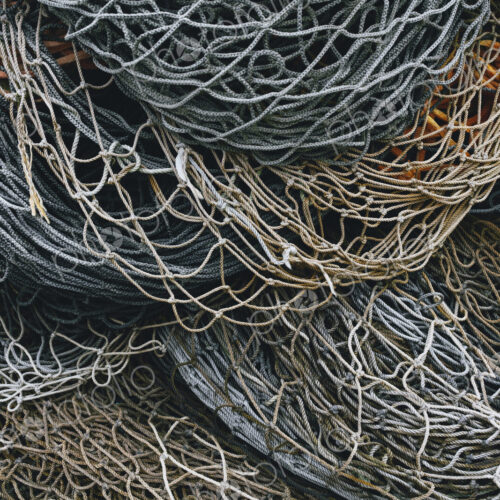 A heap of commercial fishing nets on the quayside. A heap of commercial fishing nets on the quayside.