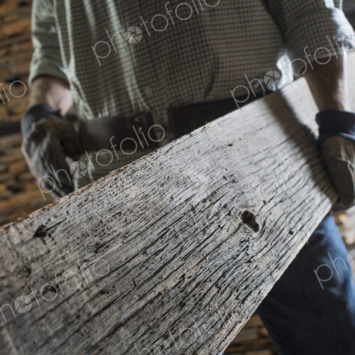 A heap of recycled reclaimed timber planks of wood. Environmentally responsible…