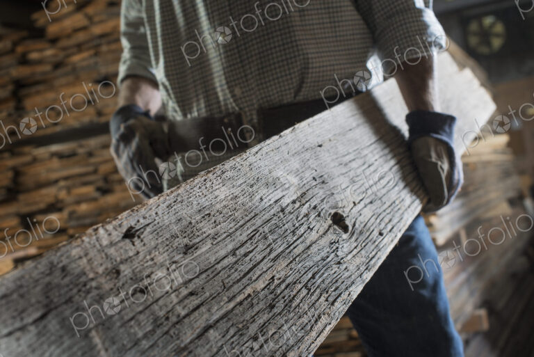 A heap of recycled reclaimed timber planks of wood. Environmentally responsible…