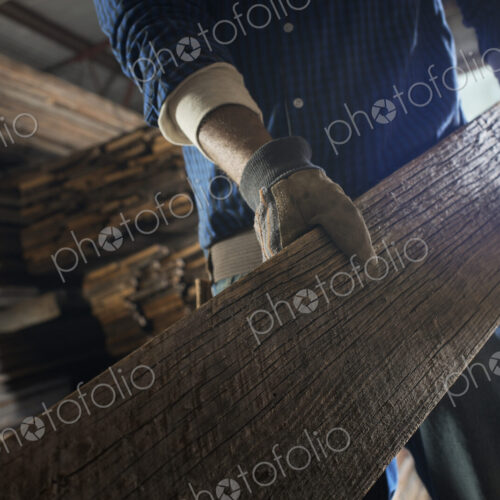 A heap of recycled reclaimed timber planks of wood. Environmentally responsible…