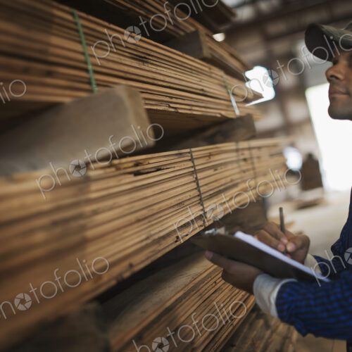 A heap of recycled reclaimed timber planks of wood. Environmentally responsible…