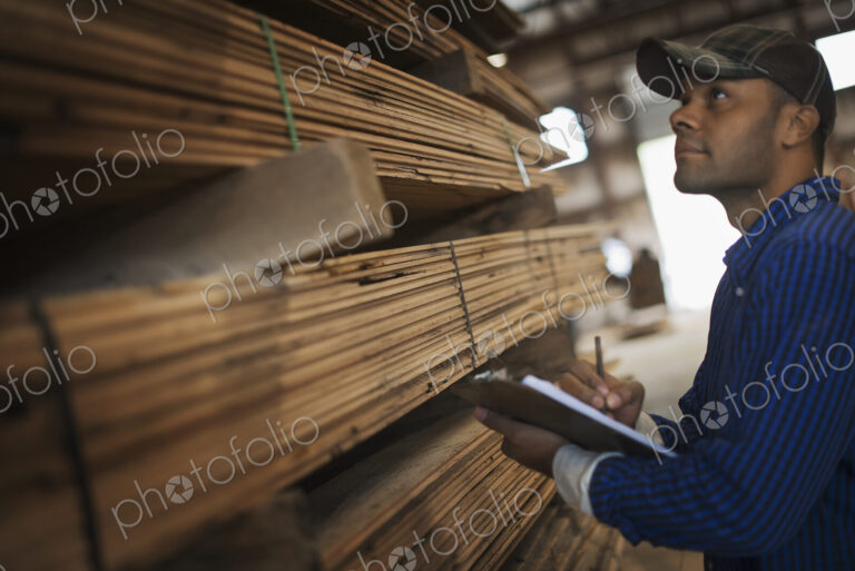 A heap of recycled reclaimed timber planks of wood. Environmentally responsible…