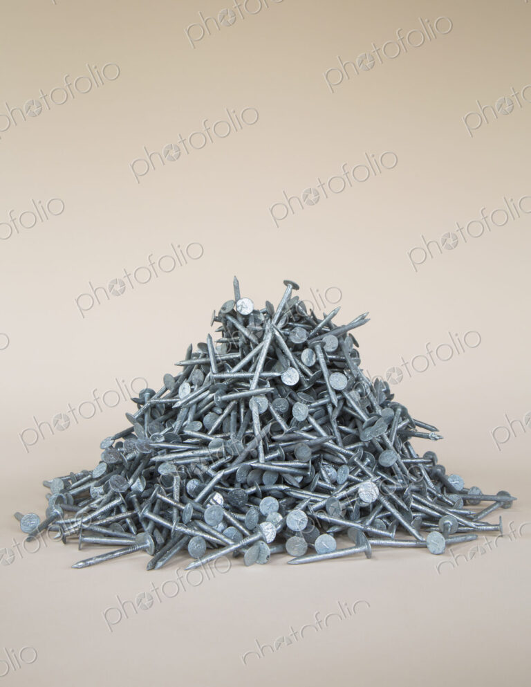 A heaped pile of galbanised nails.