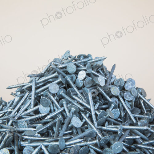 A heaped pile of galbanised nails.