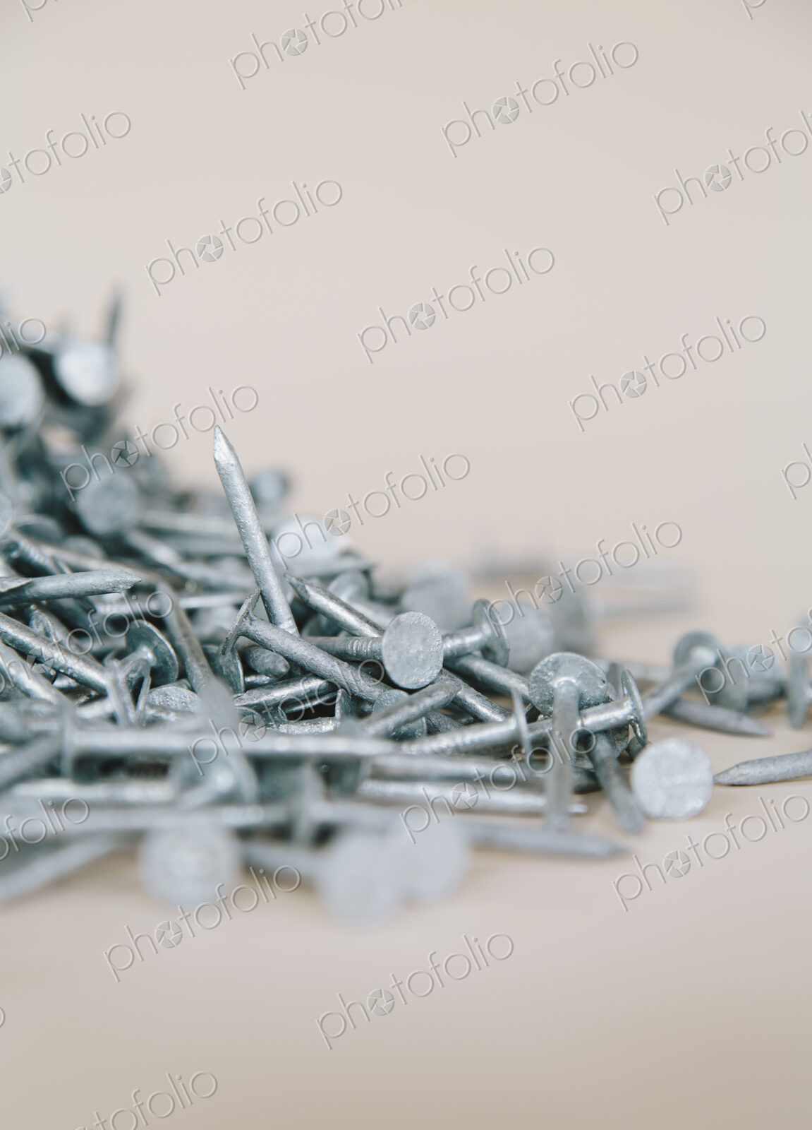 A heaped pile of galbanised nails.