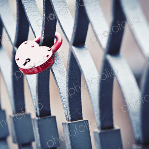 A heart shaped lock left by two lovers on a bridge railing in the city of love, Venice A heart shaped lock left by two lovers on a bridge railing in the city of love, Venice