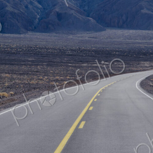 A highway curving through desolate area of Death Valley National Park, California, USA. A highway curving through desolate area of Death Valley National Park, California, USA.