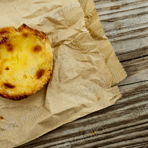 A homemade baked tart on a brown paper bag.
