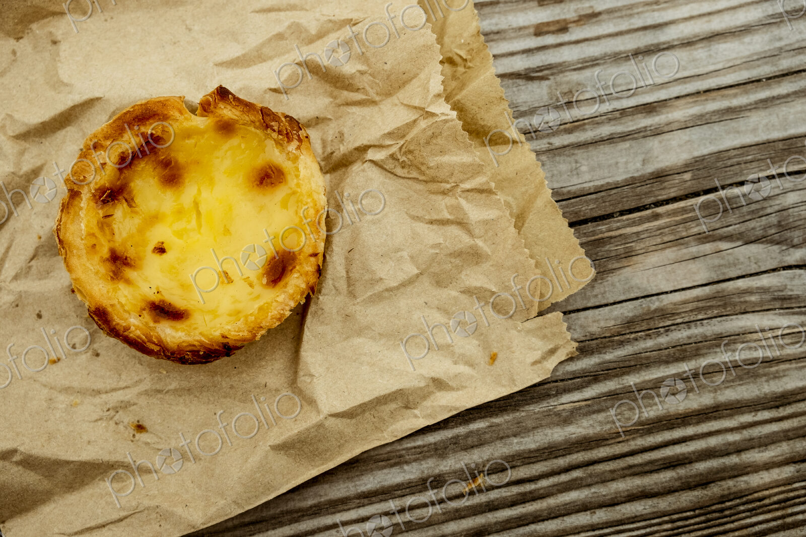 A homemade baked tart on a brown paper bag.