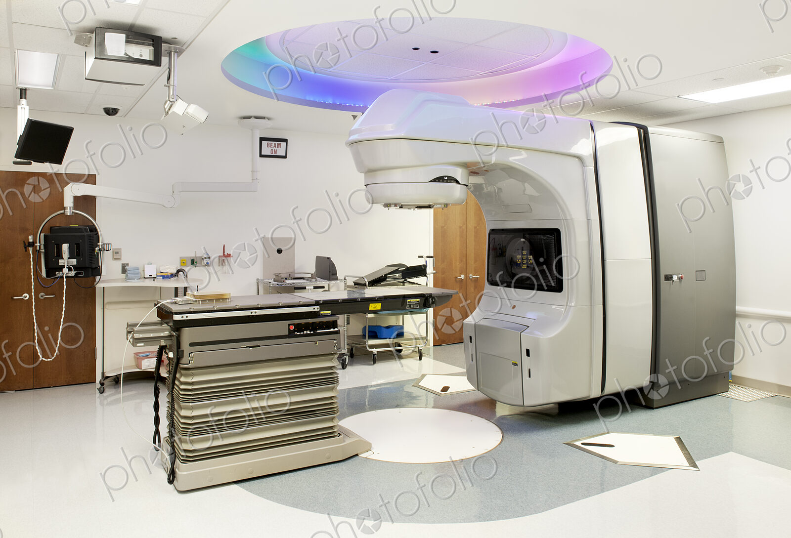 A hospital treatment room in a radiology department, with a scanning or imaging machine.