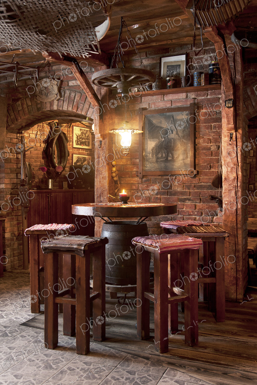 A hotel with old fashioned retro styled rooms, and rustic objects, bar table and stools.