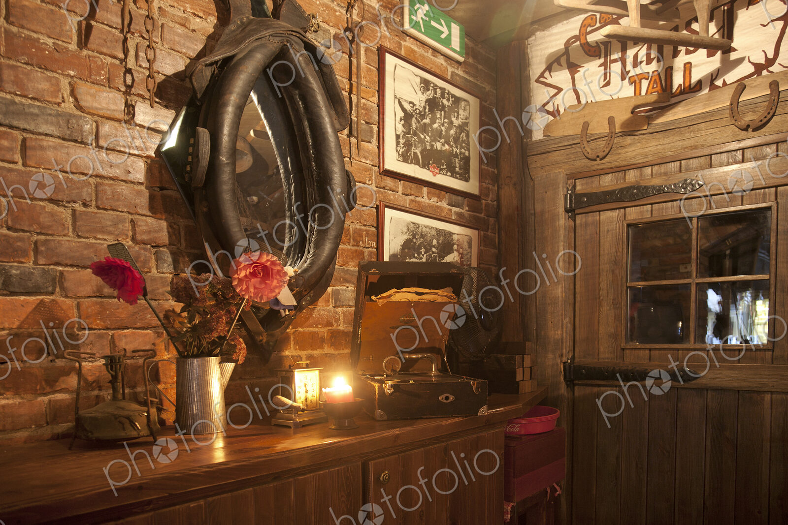 A hotel with old fashioned retro styled rooms, and rustic objects, bar with horse harness.