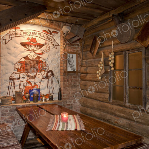 A hotel with old fashioned retro styled rooms, and rustic objects, bench and tables A hotel with old fashioned retro styled rooms, and rustic objects, bench and tables