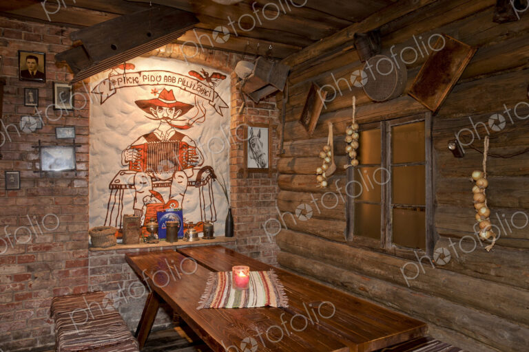A hotel with old fashioned retro styled rooms, and rustic objects, bench and tables