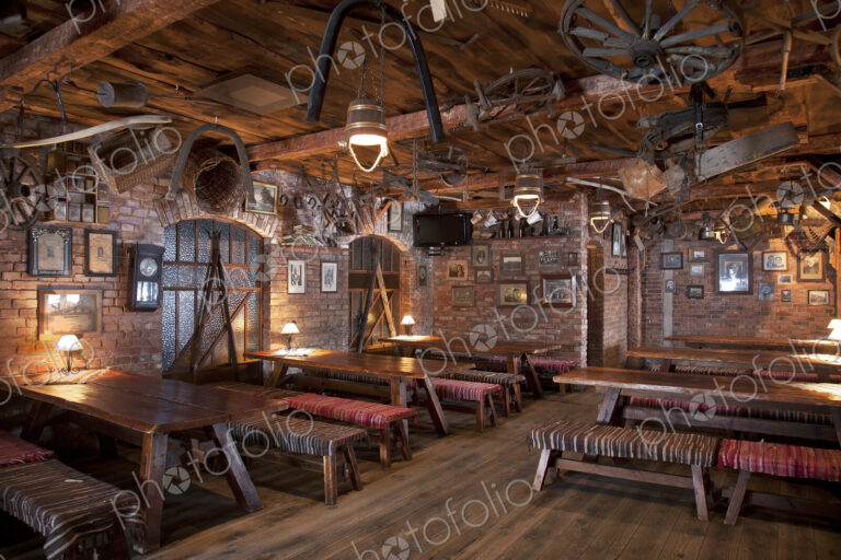 A hotel with old fashioned retro styled rooms, and rustic objects, cafe with tables…