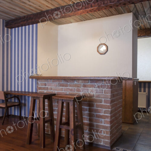 A hotel with old fashioned retro styled rooms, bar with two bar stools and striped… A hotel with old fashioned retro styled rooms, bar with two bar stools and striped…
