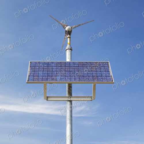 A hybrid solar panel and wind turbine system against a clear blue sky near Manderson,… A hybrid solar panel and wind turbine system against a clear blue sky near Manderson,…