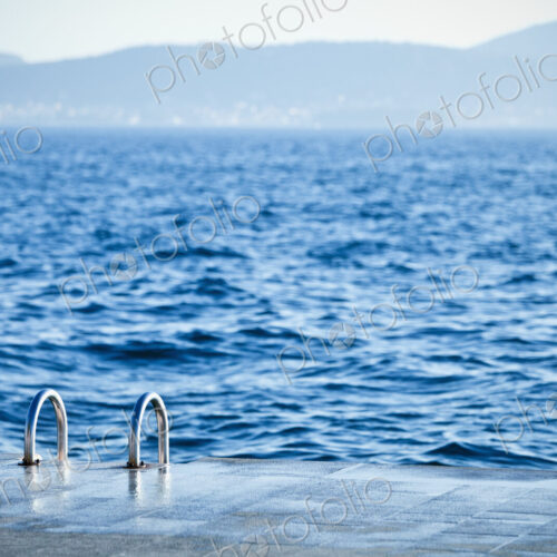 A ladder leading down to the water for swimmers in the Old City district of Zadar,…