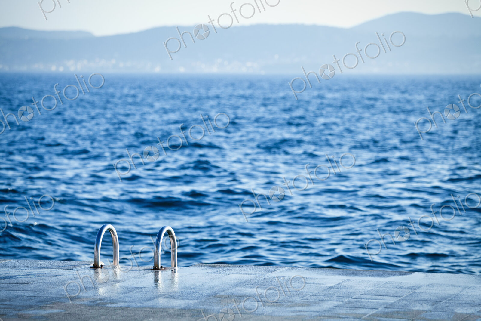 A ladder leading down to the water for swimmers in the Old City district of Zadar,…