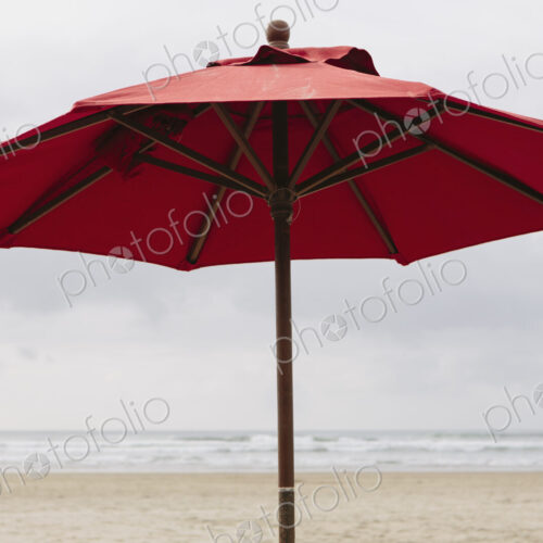 A large beach umbrella on the beach at Manzanita, on the Pacific Ocean in Oregon.