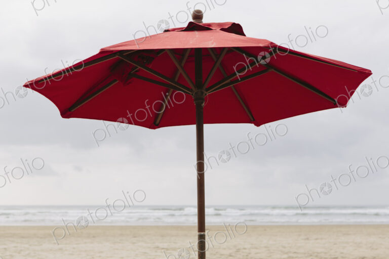 A large beach umbrella on the beach at Manzanita, on the Pacific Ocean in Oregon.