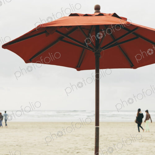 A large beach umbrella on the beach at Manzanita, on the Pacific Ocean in Oregon.