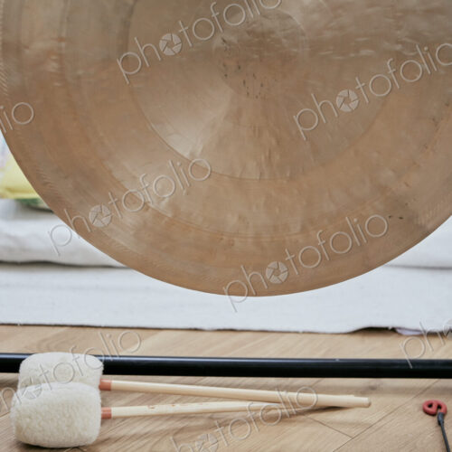 A large brass gong used for sound therapy
