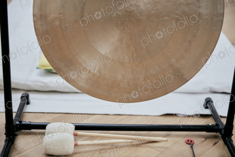 A large brass gong used for sound therapy