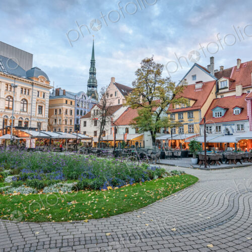 A large cioty square in Riga, historic buildings, cafes and cobbles, with planted… A large cioty square in Riga, historic buildings, cafes and cobbles, with planted…