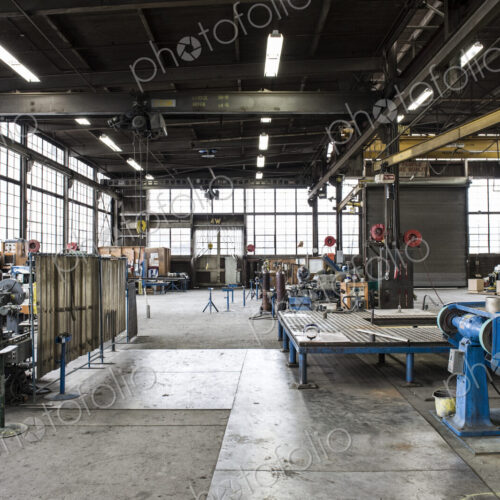 A large empty open plan engineering workshop, with machinery