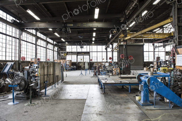 A large empty open plan engineering workshop, with machinery