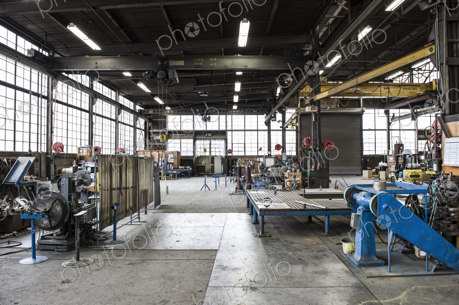 A large empty open plan engineering workshop, with machinery