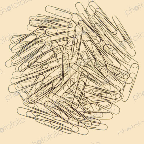 A large group of metal paperclips on a pale background.
