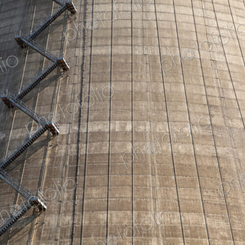 A large tower with a zigzag staircase on the side, energy production plant. A large tower with a zigzag staircase on the side, energy production plant.