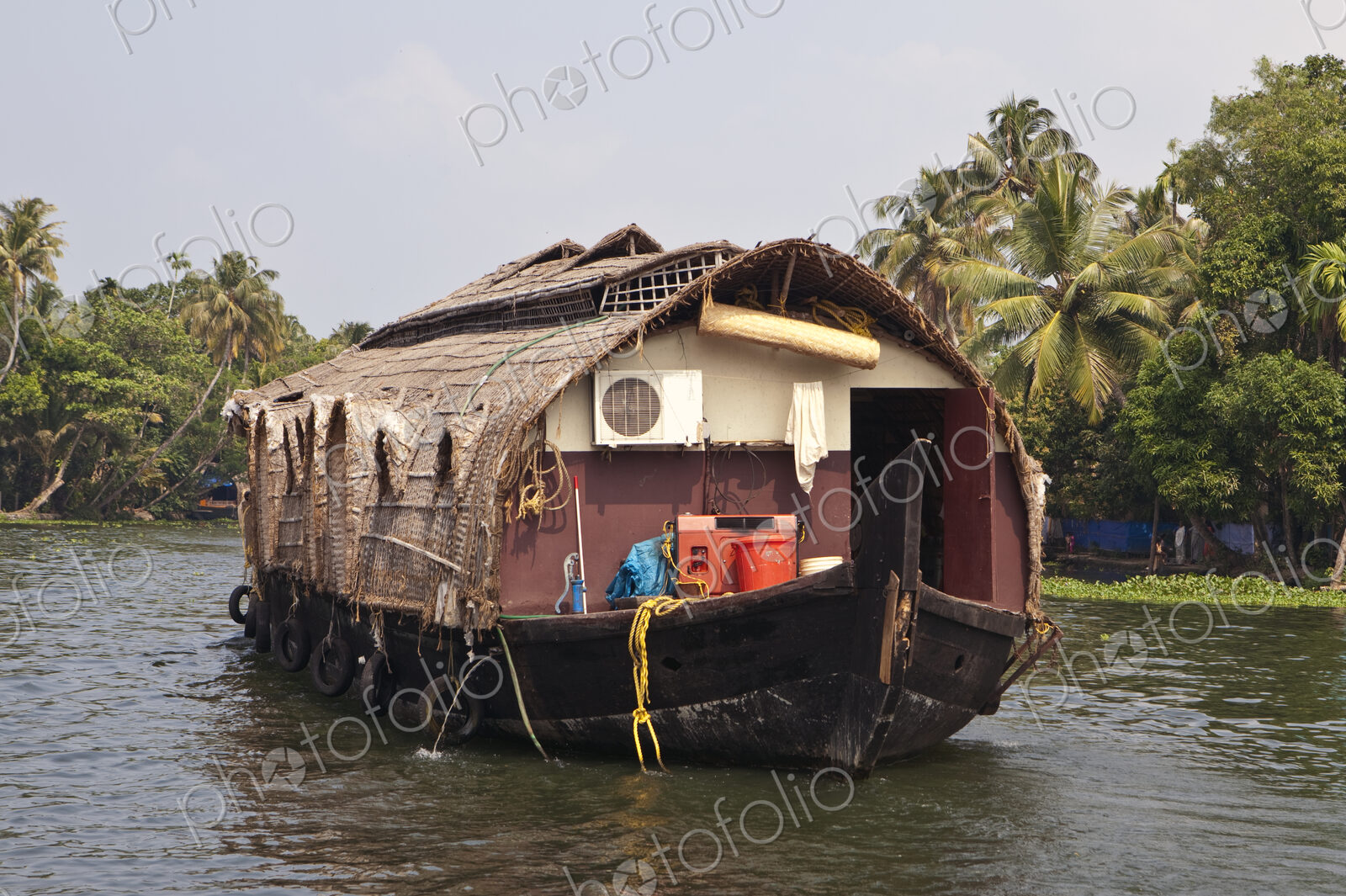 A large traditional houseboat and barge on the waters near Alleppey, India