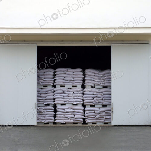 A large warehouse entrance. blocked with stacked pallets of goods.