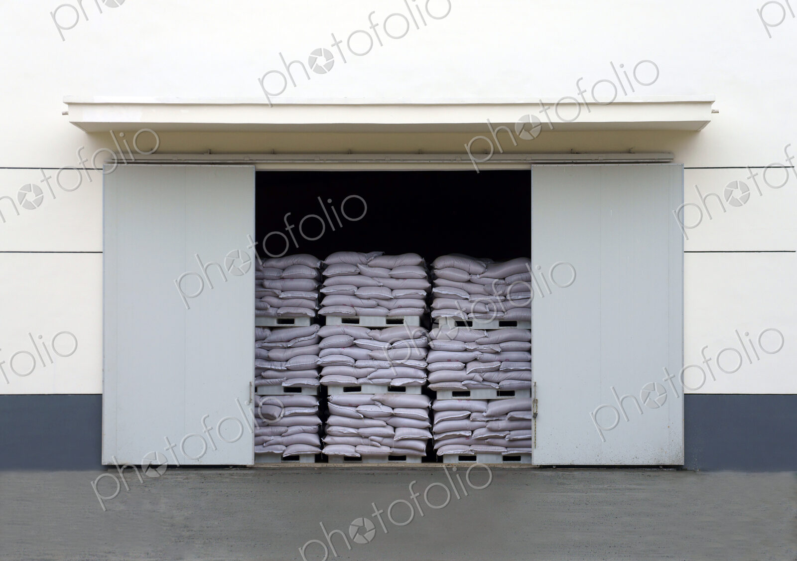 A large warehouse entrance. blocked with stacked pallets of goods.