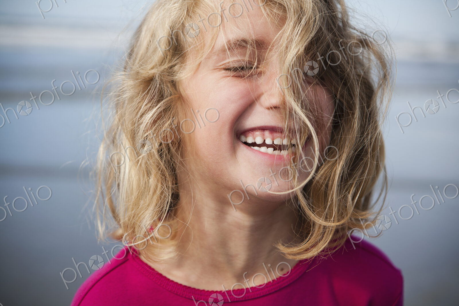 A laughing six year old gir. A portrait.