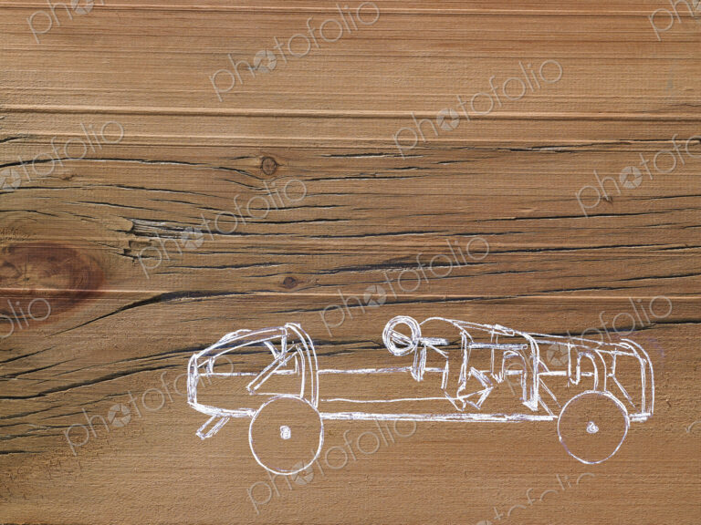 A line drawing image on a natural wood grain background. Side profile of a low sporty…