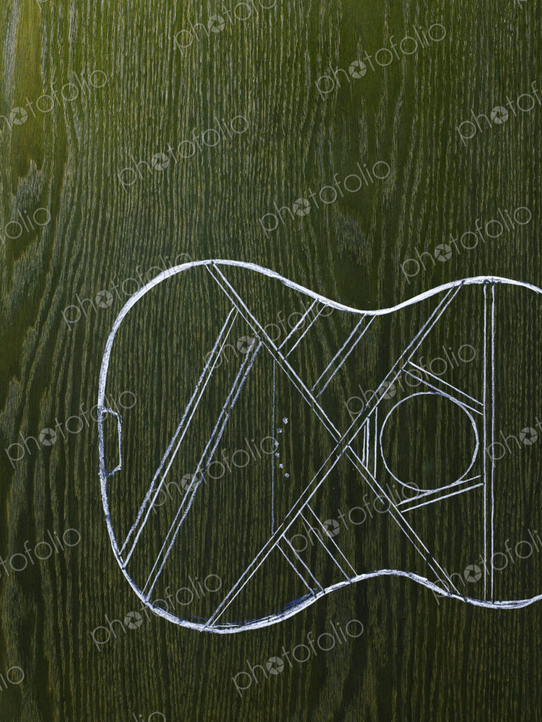 A line drawing image on a natural wood grain background. The sound board and body of a…