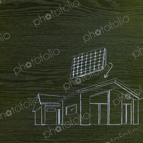 A line drawing image on grained wood. A green building project, a house with solar… A line drawing image on grained wood. A green building project, a house with solar…