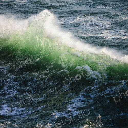 A line of white surf with green and turquoise colours in the water. Waves breaking at…