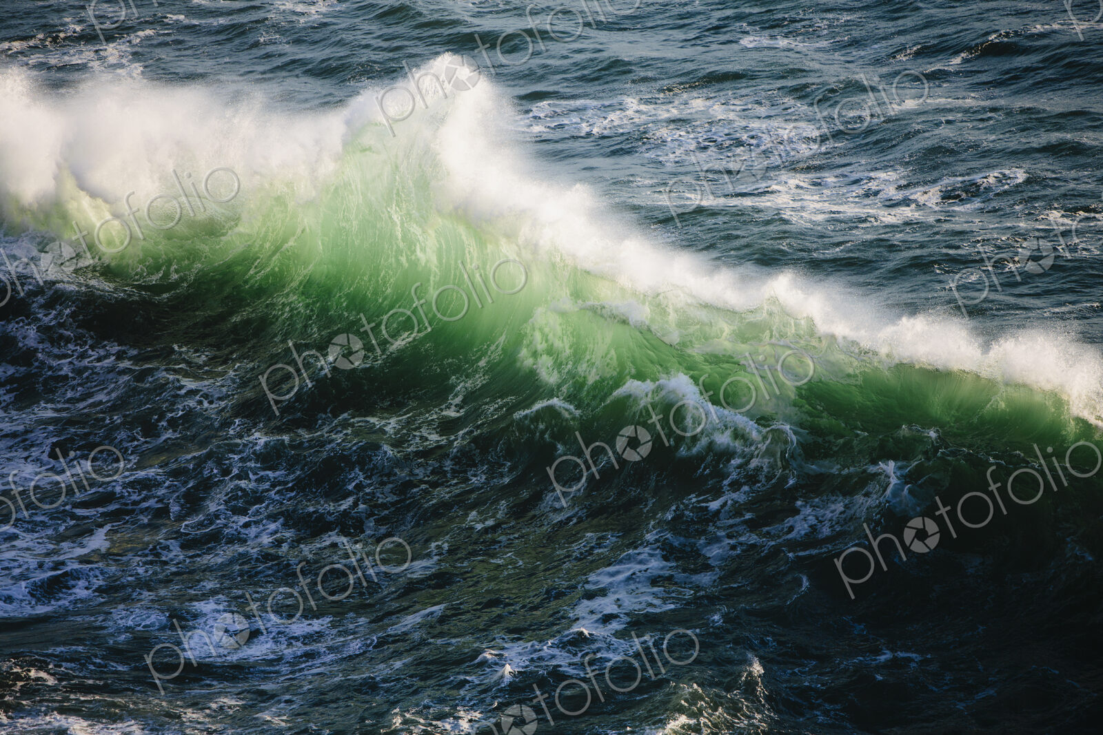 A line of white surf with green and turquoise colours in the water. Waves breaking at…