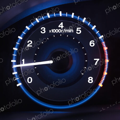 A lit up car dashboard guage, rev counter. A lit up car dashboard guage, rev counter.